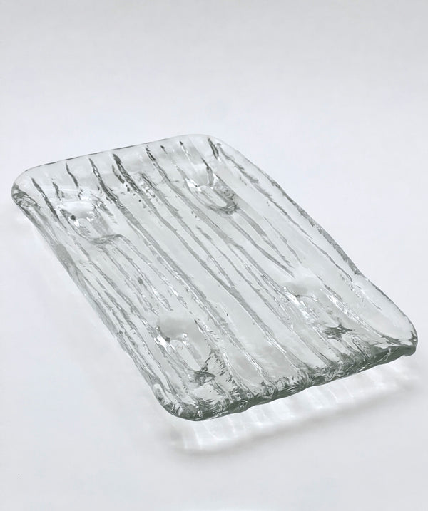 Rectangular glass tray with textured surface on a white background