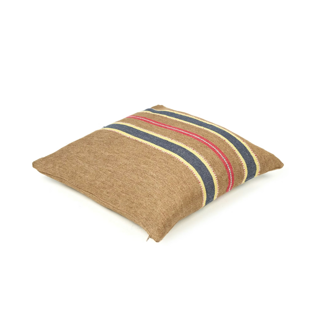 Striped pillow with brown, blue, and red pattern on a white background