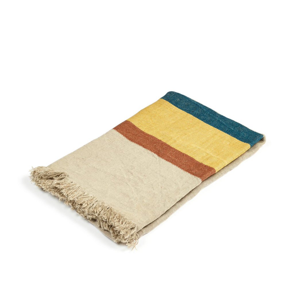 Colorful striped blanket towel with frayed edges on a white background