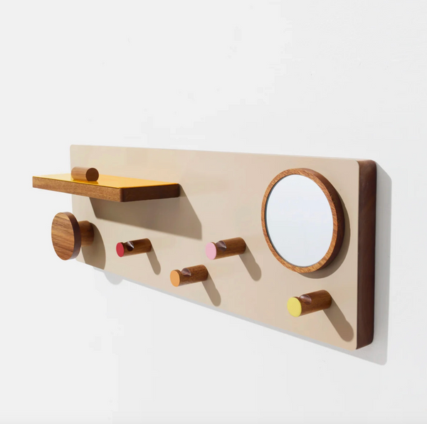 Wooden wall-mounted shelf with hooks and a small mirror on a white background