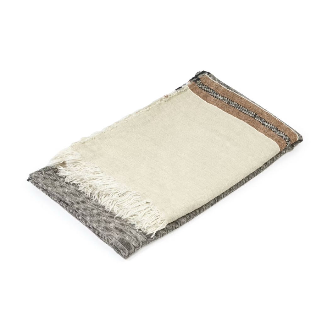 Folded blanket with gray and beige colors on a white background