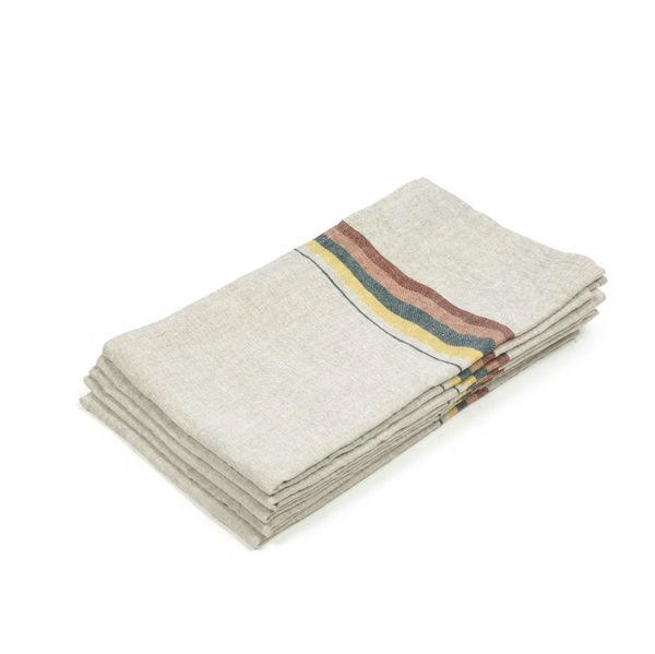 Stack of folded beige towels with colorful stripes on a white background