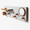 Wall-mounted coat rack with wooden hooks and a round mirror on a white background