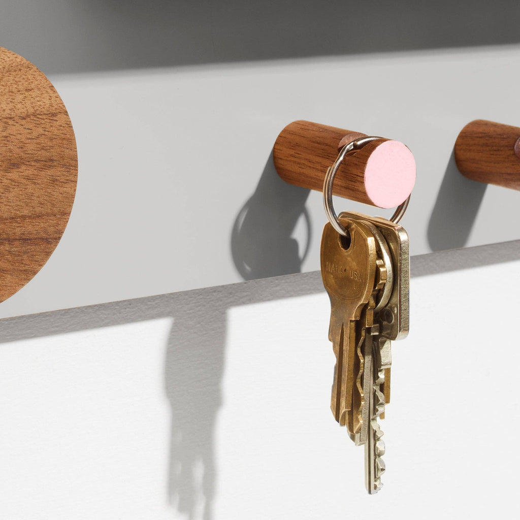 Wooden key holder with keys on a white background