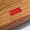 Red logo on a wooden surface