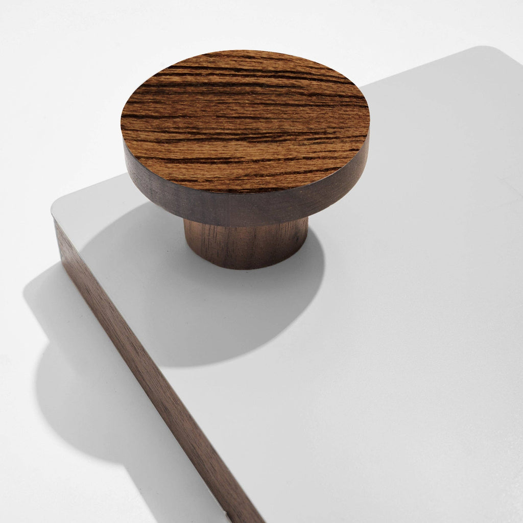 Wooden hook on a white surface