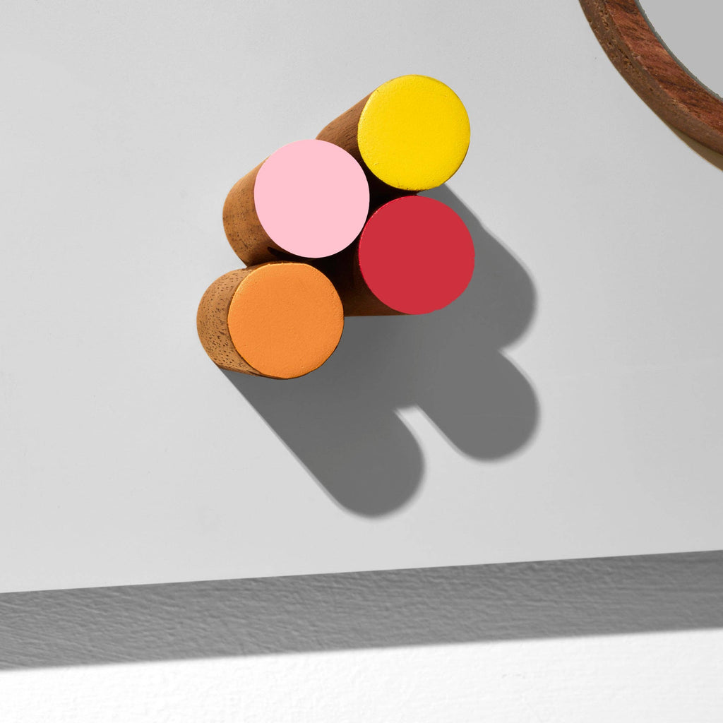Colorful round objects on a gray surface with a white background