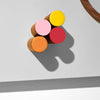 Colorful round objects on a gray surface with a white background