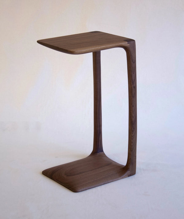 Wooden side table with a minimalist design on a white background