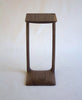Wooden stool with a square seat and curved legs on a white background