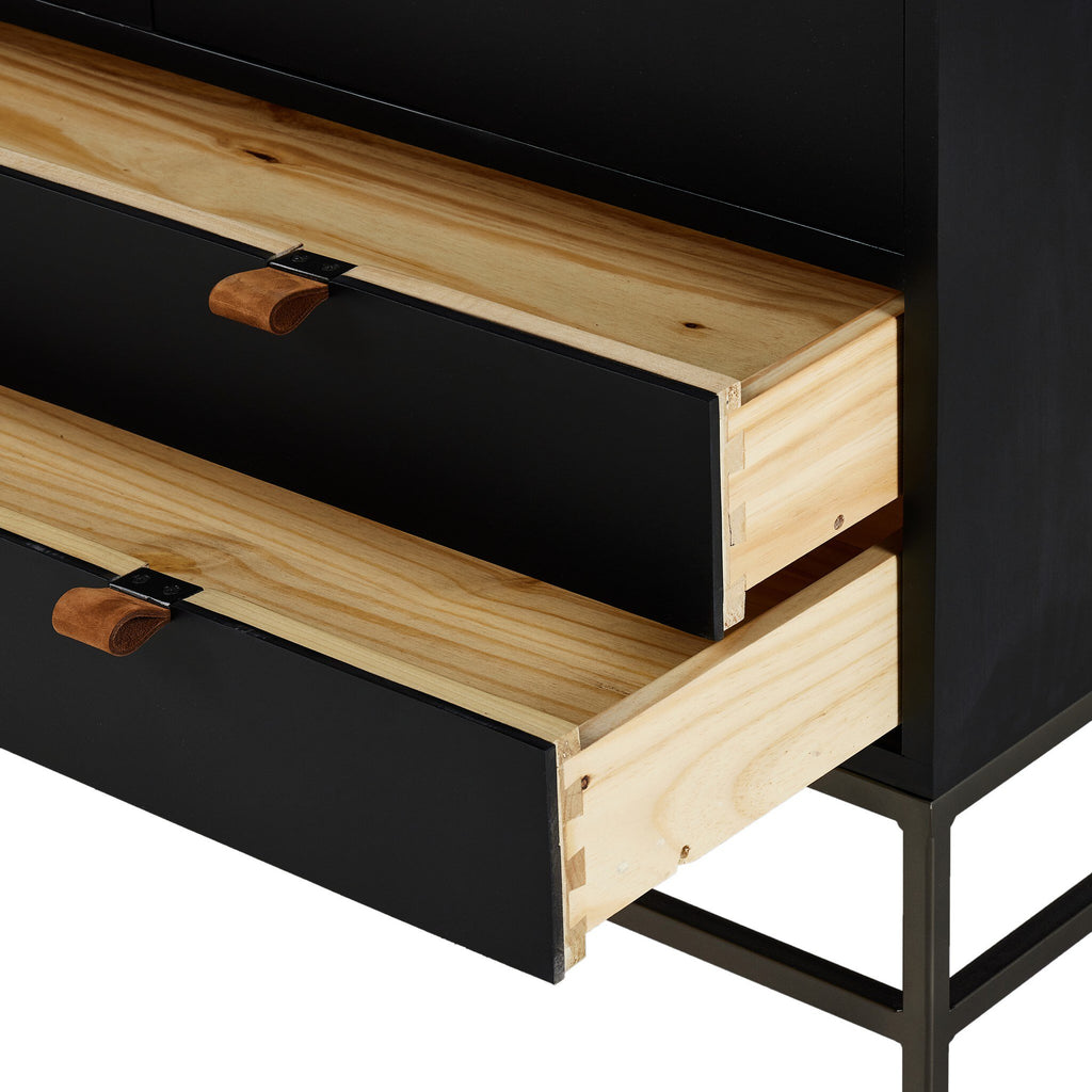 Wooden drawers with black fronts and metal handles on a black frame.