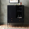 Black bar cabinet with open doors displaying bottles and glasses against a gray wall.