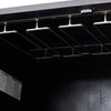 Close-up of a black wood cabinet with glassware storage