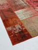 Patchwork rug with multicolor pattern on a white background
