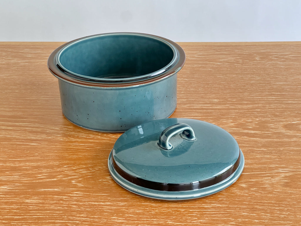 Blue ceramic pot with lid on a wooden surface