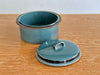 Blue ceramic pot with lid on a wooden surface