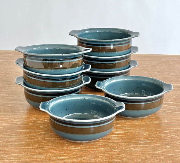 Set of ceramic bowls with blue and brown design on a wooden surface
