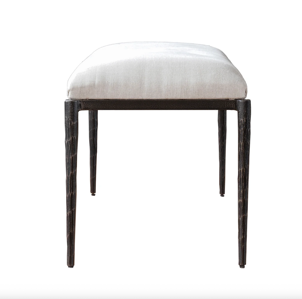 Stool with white cushioned seat and dark wooden legs on a white background