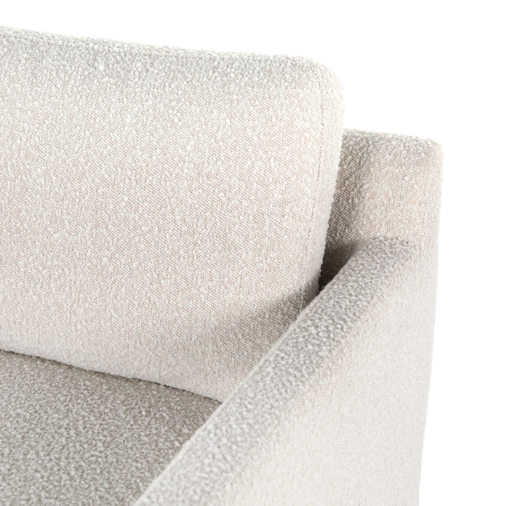 Close-up of a textured gray sofa corner on a white background