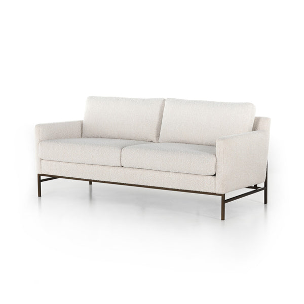 Beige sofa with metal frame on a white background