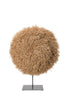Decorative sphere made of natural materials on a stand against a white background