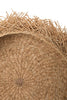 Close-up of a woven straw mat with natural brown color on a white background