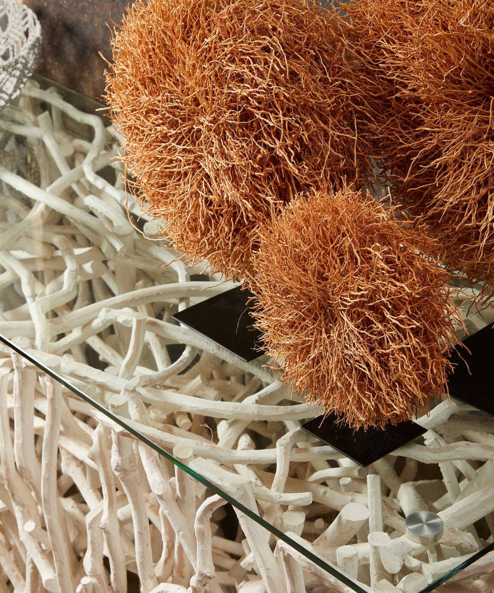 Decorative nest vetiver root with brown material on a textured white surface