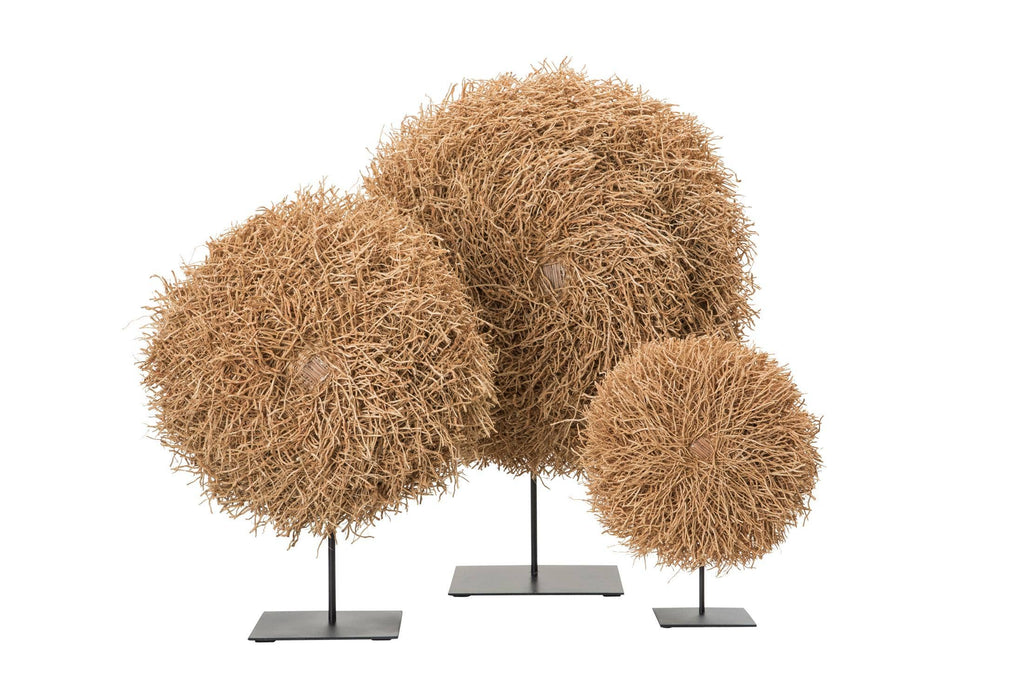 Three decorative nest made of natural material on stands against a white background. 