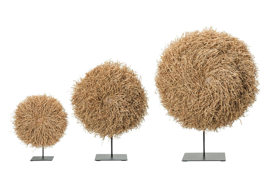 Three decorative spherical objects on stands against a white background