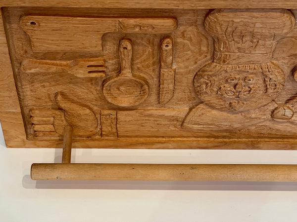 Wooden panel with intricate carvings of abstract shapes and symbols