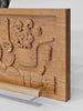 Wooden panel with intricate carvings on a white background