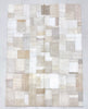 Patchwork rug with beige and brown squares on a light gray background