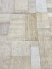 Textured patchwork pattern with beige and brown tones