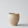 Wooden vase on a light gray background