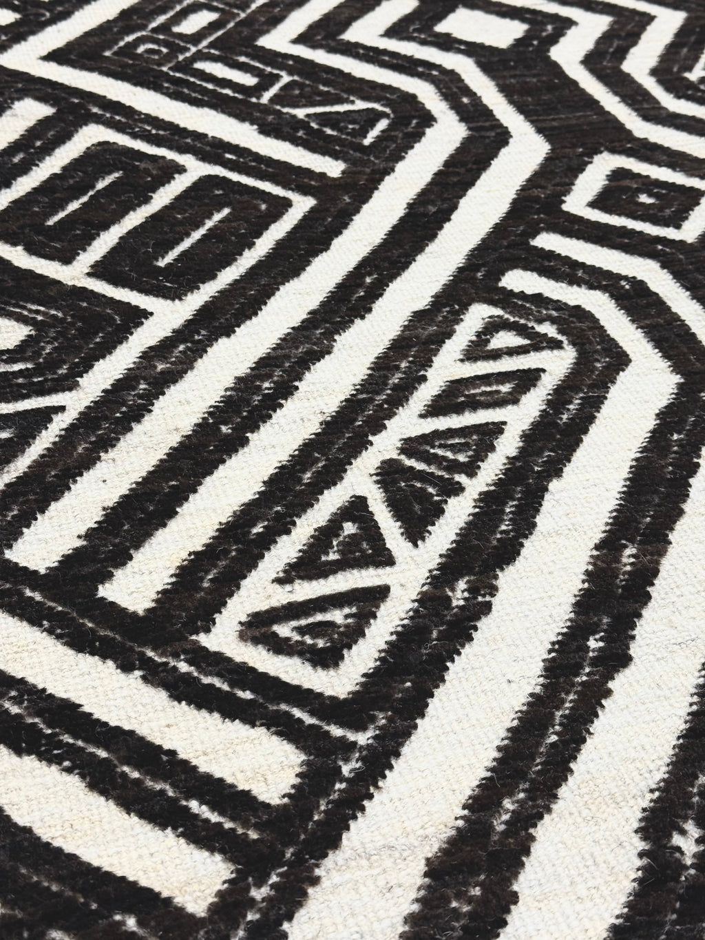 Close-up of a black and white geometric patterned rug