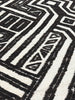 Close-up of a black and white geometric patterned rug