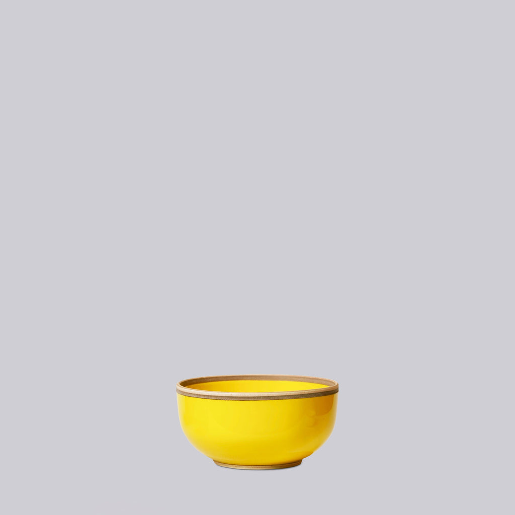 Yellow ceramic porcelain bowl on a gray background