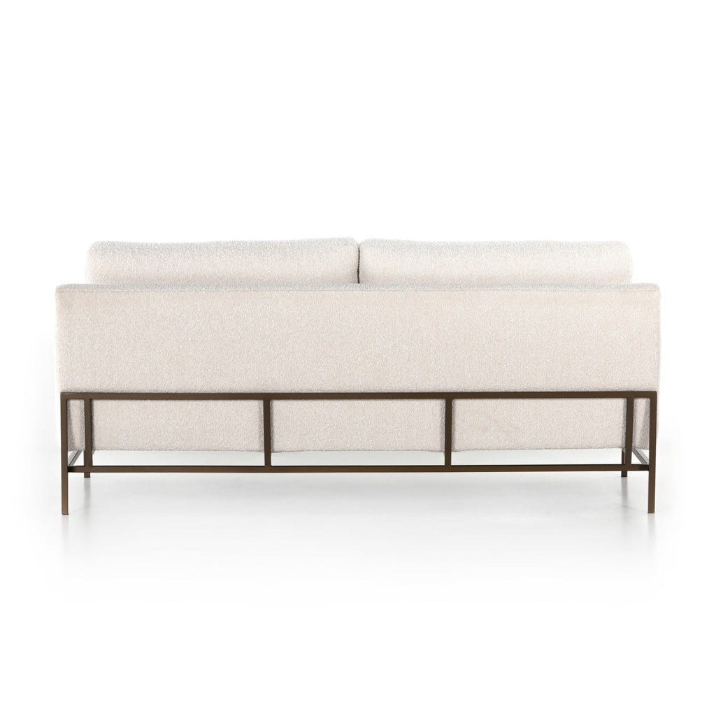Modern white sofa with metal frame on a white background