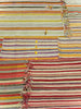 Striped rug with multicolor pattern and frayed edges