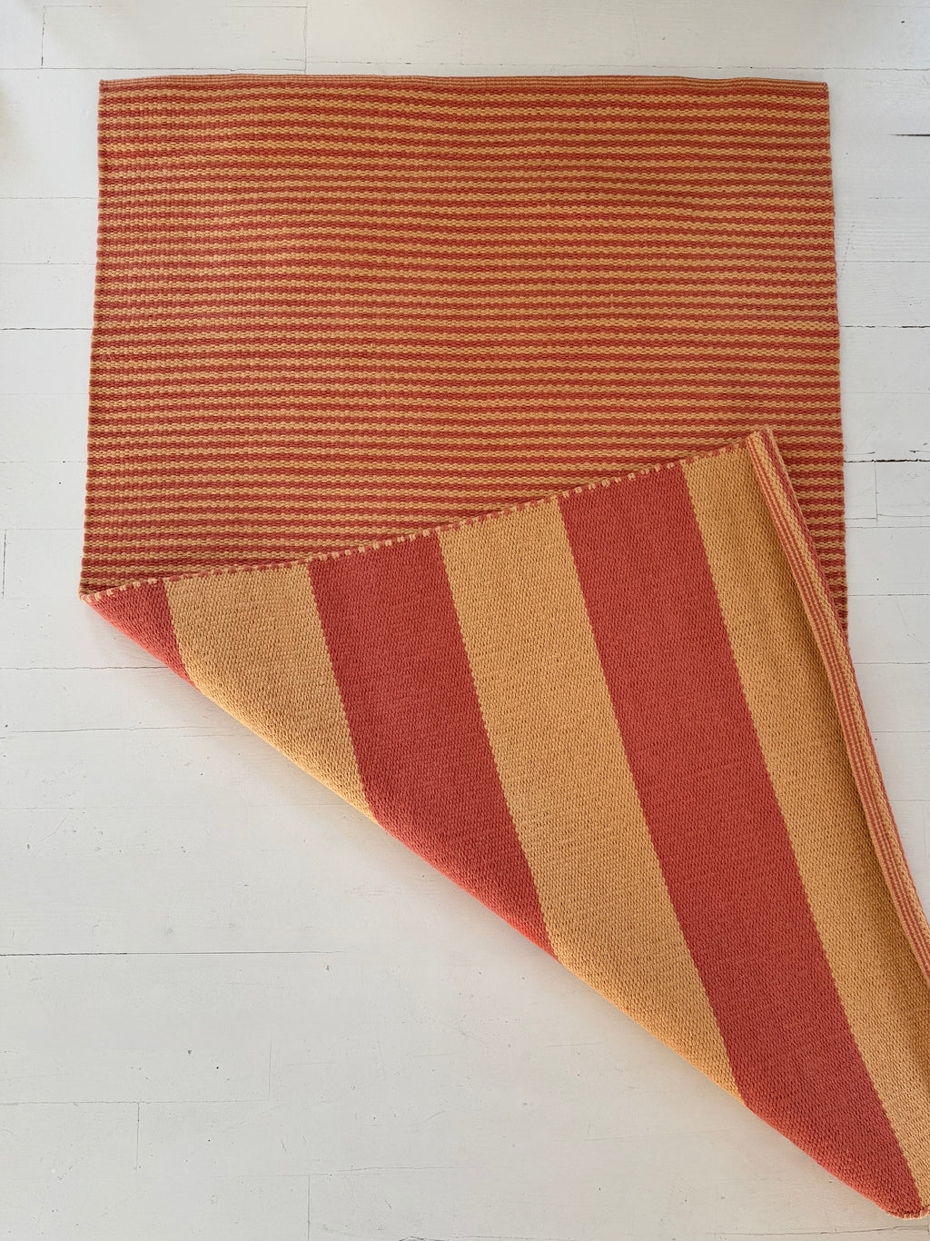 Striped fabric with red and brown colors on a white background