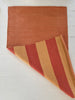 Striped fabric with red and brown colors on a white background
