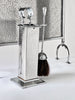 Decorative chrome fireplace tool set with broom and brush on a white background